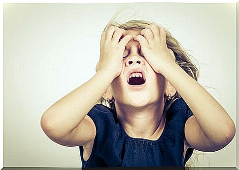 Little girl anxiously with her hands on her head