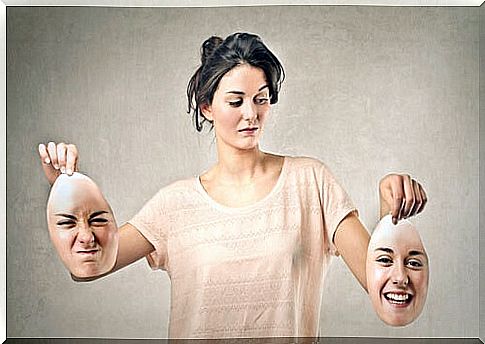 Woman holding two faces one angry and the other smiling