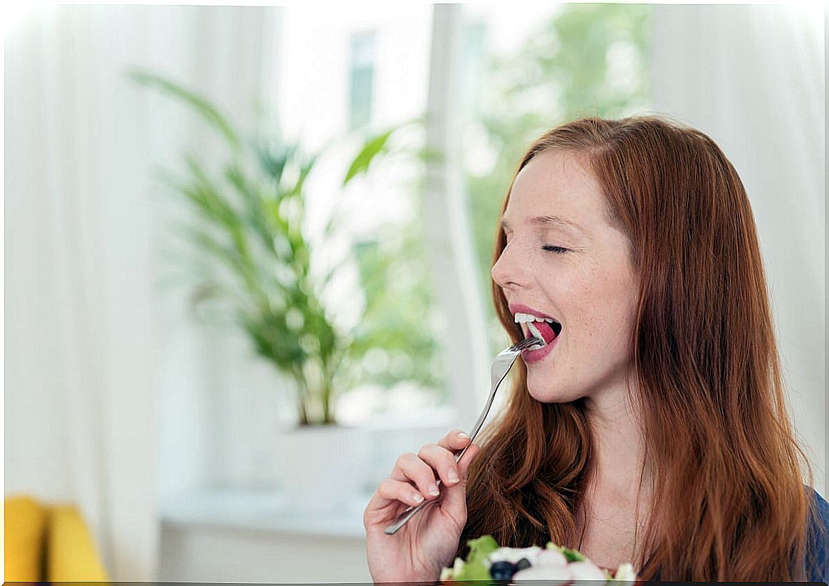 Woman eating with eyes closed