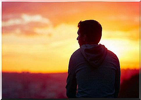 Man from behind watching the sunset