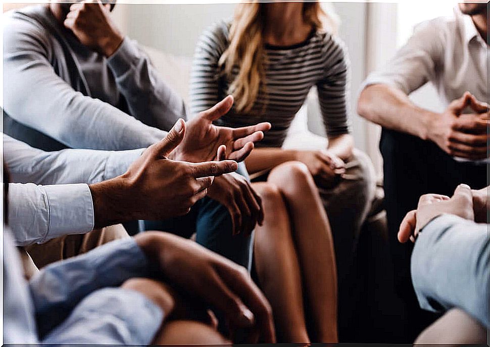 Man talking to people after overcoming his fear of public speaking