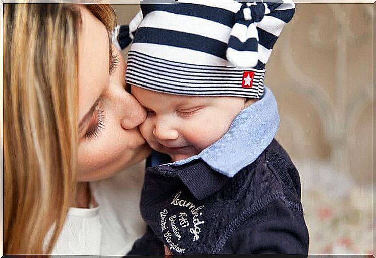 Mom giving her baby a kiss