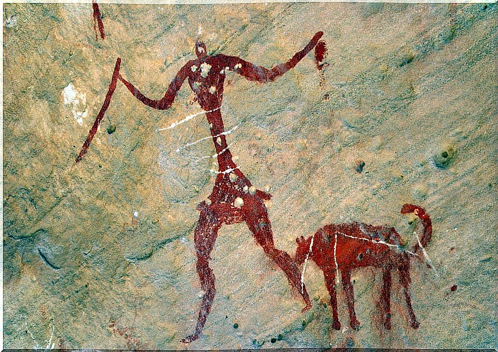 Cave painting of a man with his dogs depicting empathy in dogs