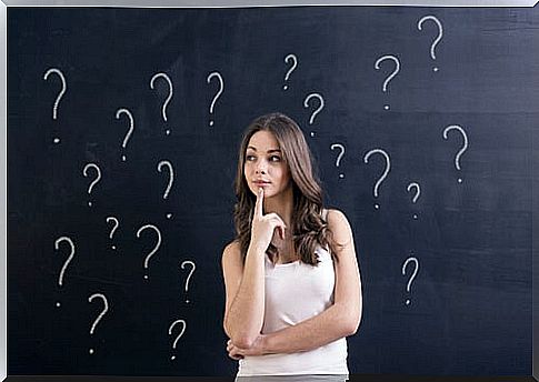 Woman thinking about failure surrounded by question marks