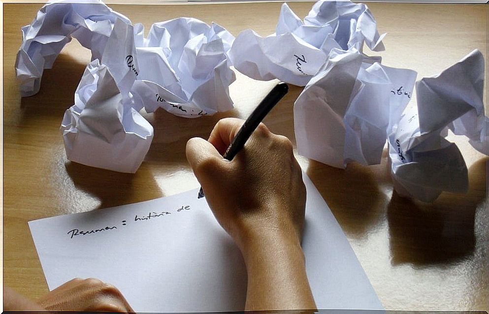 Person writing on a sheet of paper