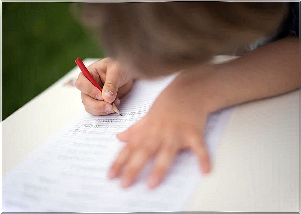 Boy writing in notebook