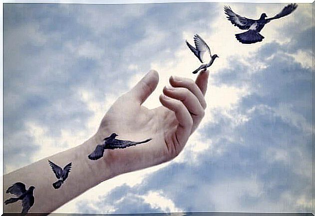 Hands releasing birds symbolizing psychological reactance