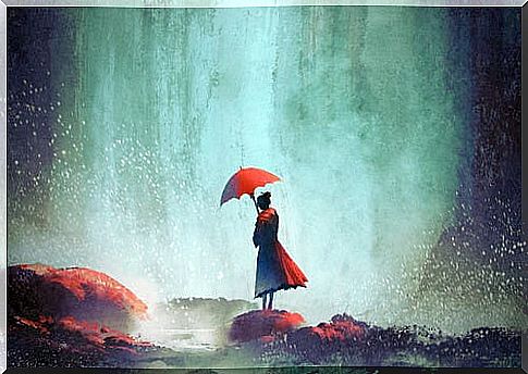 Lonely woman with a red umbrella thinking about alone time