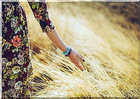 Woman walking through field applying savoring technique