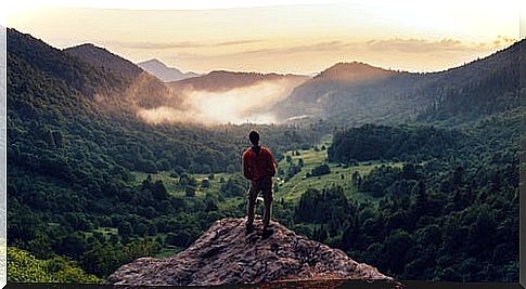 man on mountain representing the 6 strengths of character