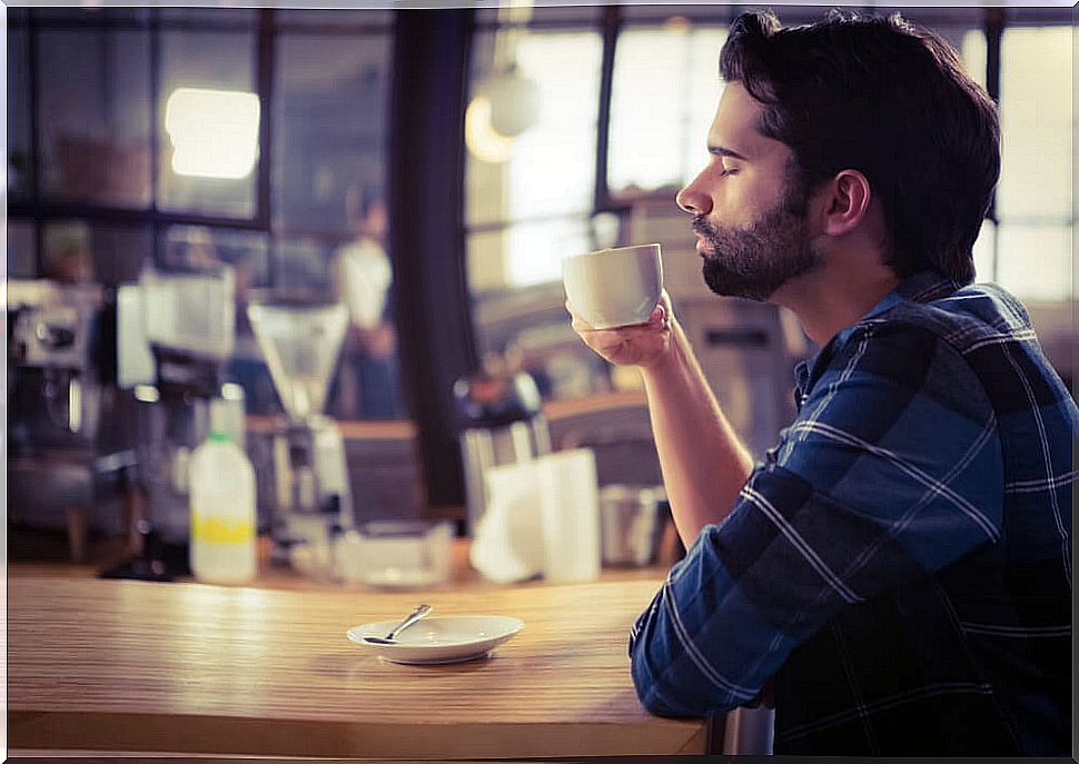 Man tasting a cup of coffee