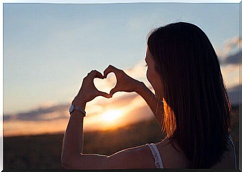 Woman making the shape of a heart with her hands