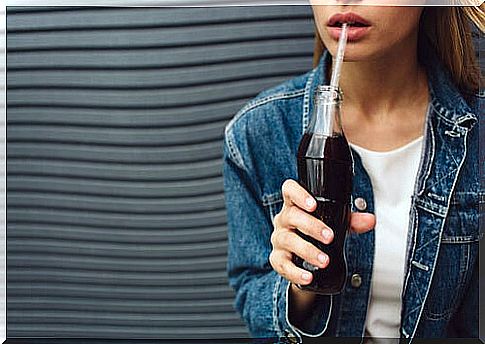 Teenage girl drinking sugary soda