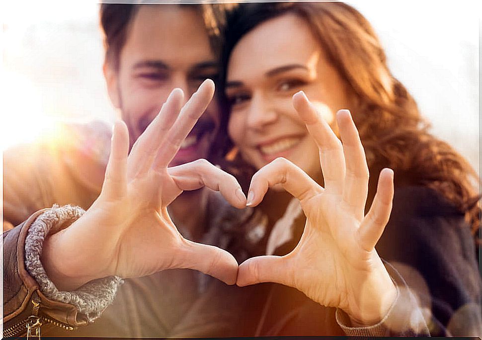 Couple forming heart with their hands