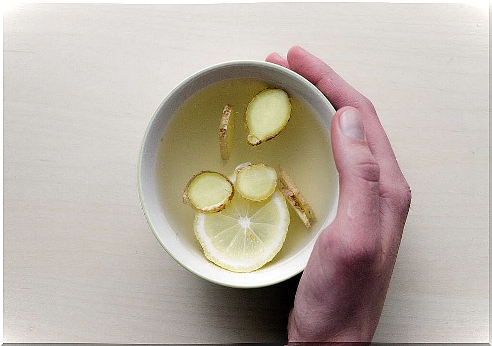 Hand with water with lemon