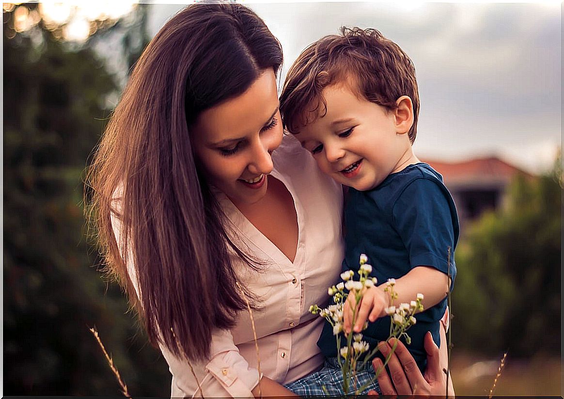 Mother and son watching a flower