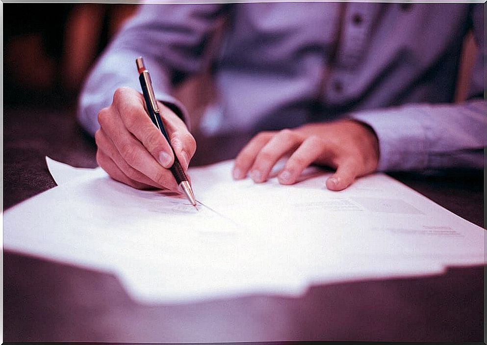 Man writing his resolutions on paper