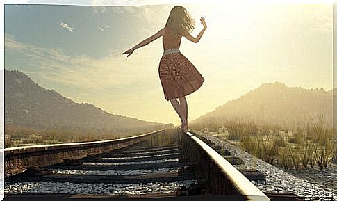 Woman walking down a track looking to the future