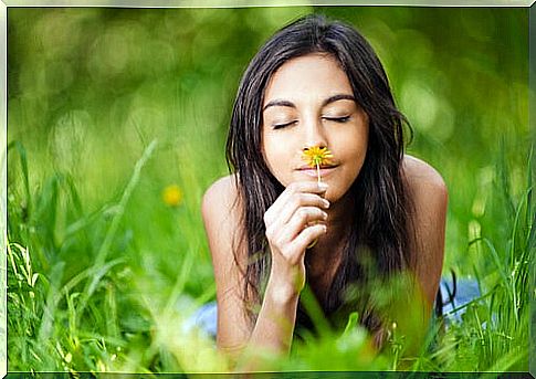 Woman smelling a flower having memories