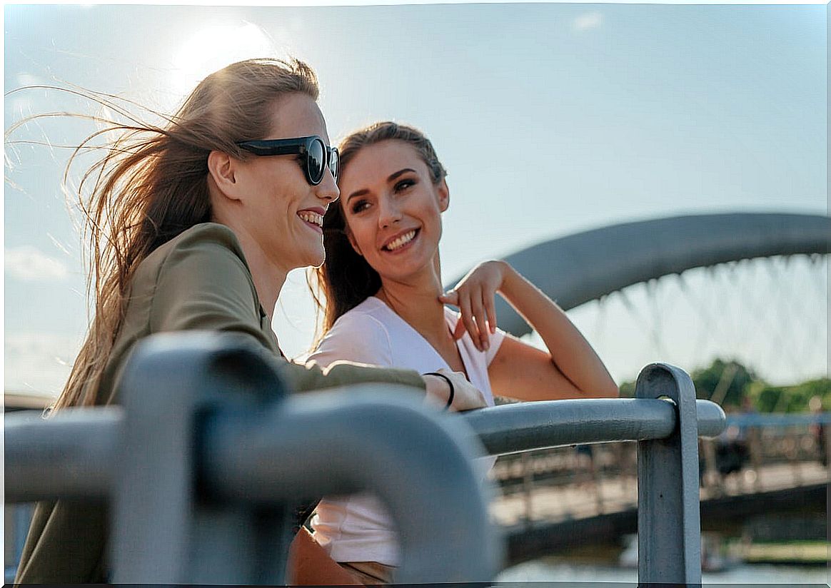 Girlfriends talking on a bridge